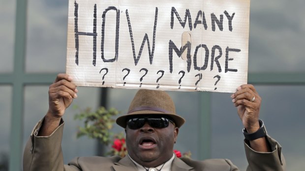 Reverend Doctor Arthur Prioleau holds a sign during a protest in the shooting death of Walter Scott at city hall in North Charleston, South Carolina. The officer, Michael Thomas Slager, has been charged with murder. 