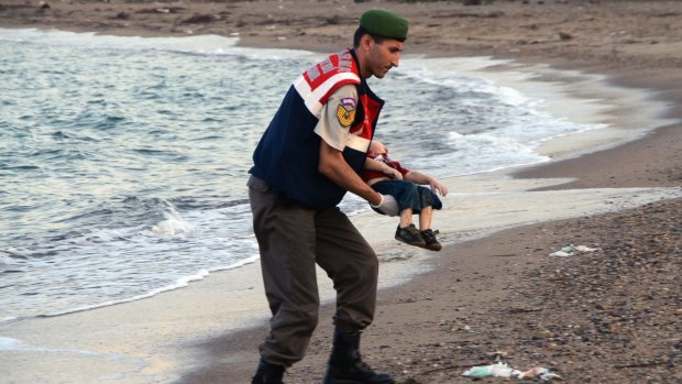 A paramilitary police officer carries the lifeless body of Alan Kurdi. The infant's death sparked an outpouring of goodwill in Australia and beyond. 
