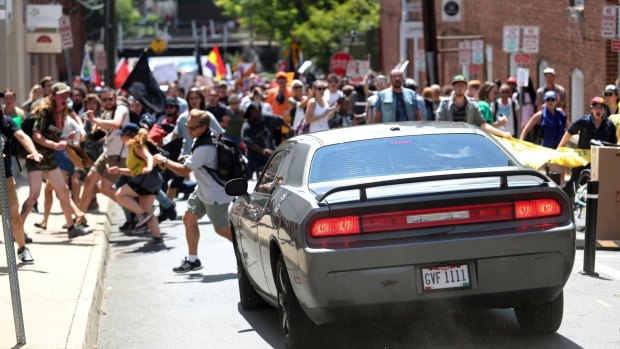 A vehicle drives into a group of protesters demonstrating against a white nationalist rally in Charlottesville.