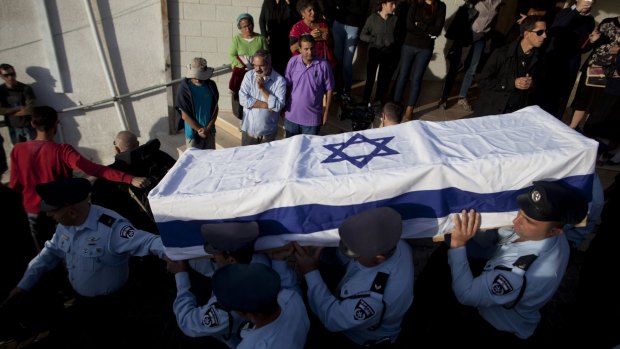 Israeli police officers carry the coffin of police officer Zidan Saif.