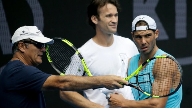 Spain's Rafael Nadal (right) with his uncle Toni Nadal (left) as Carlos Moya looks on.