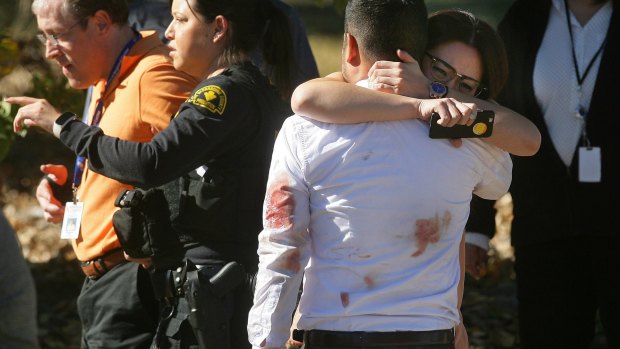 A couple embraces following the shooting.