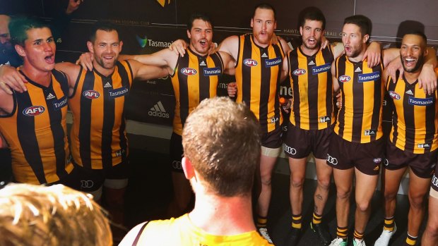 On song: Hawks players belt it out loud and proud after notching their first win of the season.