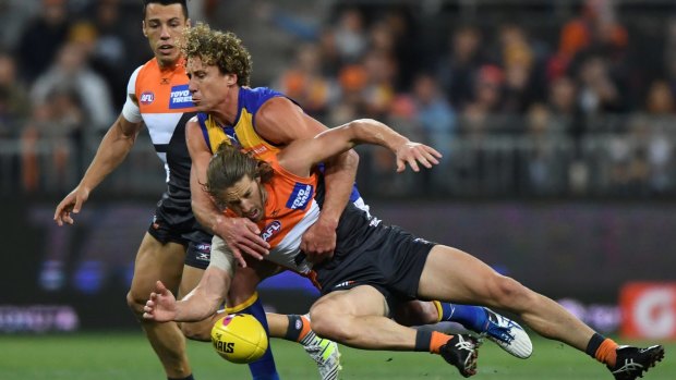 West Coast's Matt Priddis and the Giants' Callan Ward fly for the ball.