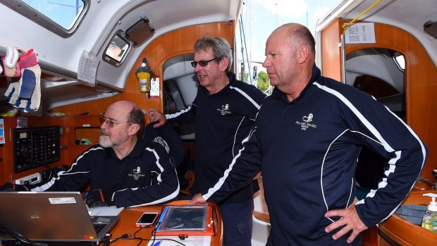 Pelagic Magic crew members former AFP Commissioner Shane Connelly (right) with the navigator Paul Jones (left) and skipper Simon Dunlop (2nd from left) preparing for the Sydney to Hobart race.