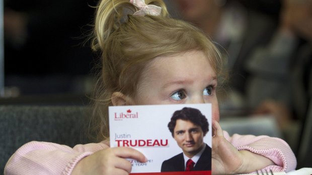 Two-year-old Ella-Grace, daughter of Liberal candidate Justin Trudeau, holds her father's election postcard in 2011. 