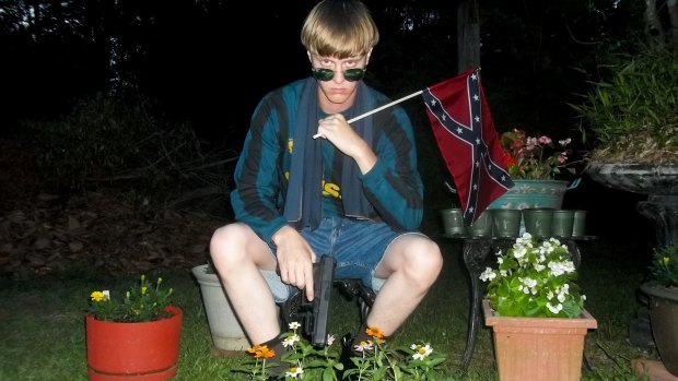 This undated image of Roof waving a confederate flag that appeared on a website being investigated by the FBI.