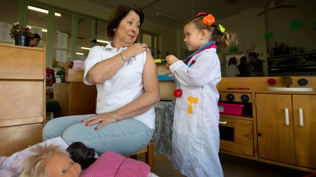 How it's done: Kindergarten co-ordinator Margaret Benincasa receives a pretend immunisation from Maeve Darwin, 4.