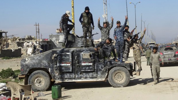 Iraqi security forces celebrate after regaining control of the town of Husaybah, 8 kilometres east of Ramadi, Iraq, after heavy clashes with Islamic State fighters.
