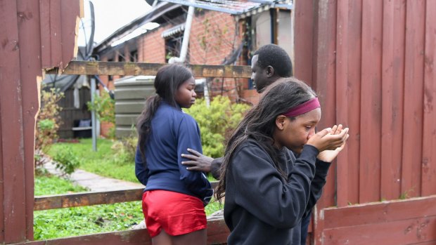 Children who live at the Cranbourne North home inspect the damage after the fire.