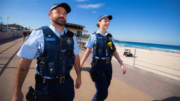 NSW police on patrol, wearing body cameras.