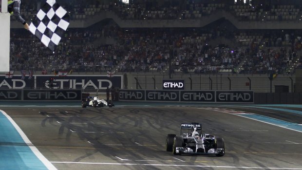 Lewis Hamilton takes the chequered flag at the Yas Marina circuit in Abu Dhabi.