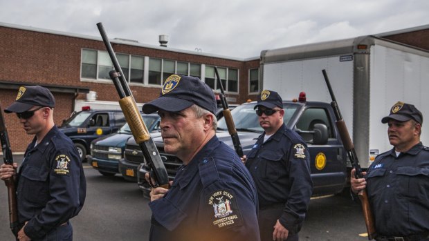 A corrections emergency response team prepares to search in and around Friendship, New York, last month. 