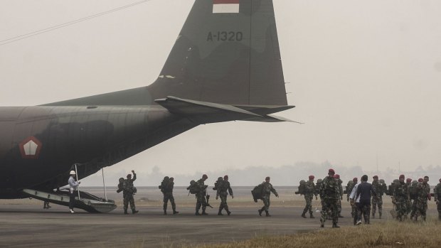 Indonesian soldiers in Palembang, South Sumatra are deployed to help contain massive fires causing widespread haze.
