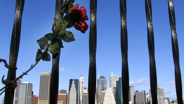 In memorial to the victims killed in the September 11, 2001, terrorist attacks on the World Trade Centre, a silk rose is tied to the fence along the Brooklyn Heights Promenade.