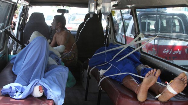 Injured men lie in an ambulance after the accident.