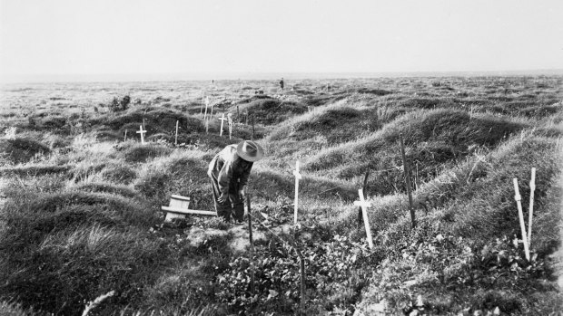 An Anzac soldier scrutinises a grave near Pozieres, along the line of OG1 trench in 1917, the year after the battle for Pozieres.