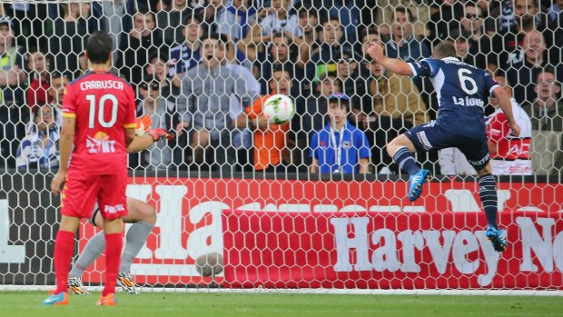Victory's Leigh Broxham heads home against Adelaide United at AAMI Park on Friday.