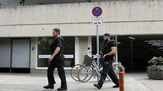 Armed police officers walk in front of the Benjamin-Franklin Hospital in Berlin.