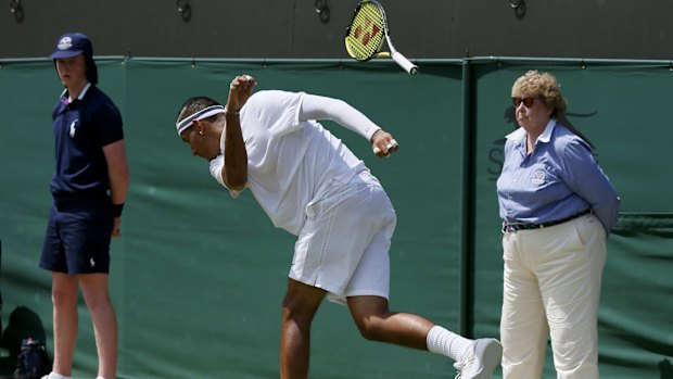 Whoops: Nick Kyrgios throws his racquet onto the ground and it bounces into the fans.