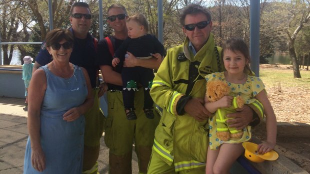 ACT Fire and Rescue officers Phil Levings, Paul Bunfield and Shane Ryan following their rescue of five-year-old Emiliana Barry, who became stuck in play equipment at Weston Park in September. She is pictured with her baby brother, Arthur and grandmother, Pauline.