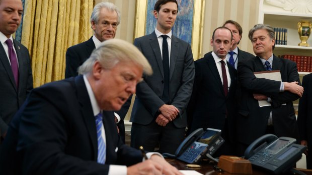 Bannon, far right, in the Oval Office with Donald Trump and his team. 