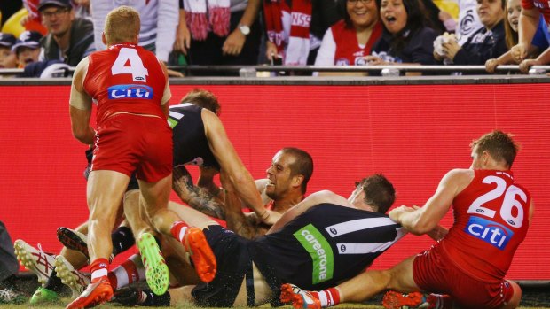 Fracas: Lance Franklin, centre, during the half-time melee sparked by his tackle on Carlton's Zach Tuohy.
