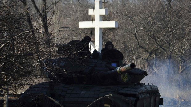 Ukrainian soldiers ride on a tank near Artemivsk in eastern Ukraine on Saturday.