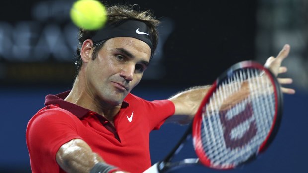 Roger Federer plays a backhand against Milos Raonic in the final of the Brisbane International.