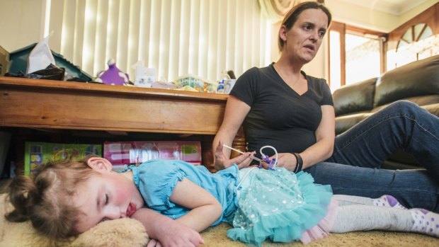 Cherie Dell gives her 3-year-old daughter Abbey a dose of cannabis oil to treat the seizures caused by a rare genetic disorder, CDKL5.