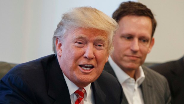 Peter Thiel, right, listens as then President-elect Donald Trump speaks during a meeting with technology industry leaders at Trump Tower in New York. 