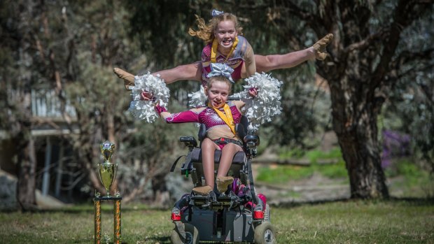 Bella Stokes (front) and Gaby Rooks (back) cheer with Sirens cheerleaders in Mitchell and are competing in the Australian All Star Cheerleading Federation nationals in November. 