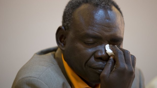 Clement Abaifouta, president of the association of victims of former Chadian dictator Hissene Habre, wipes away tears in 2013 after listening to fellow victims recount their stories.