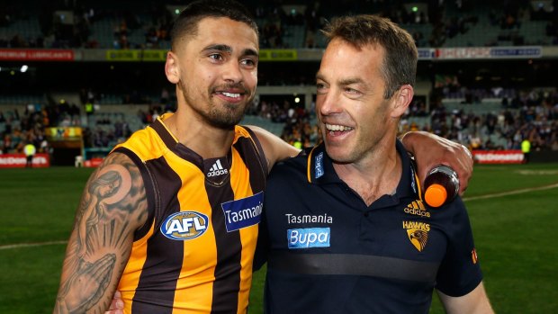 A happy Bradley Hill walks back with coach Alastair Clarkson after Hawthorn ensured their entry into a fourth straight grand final.