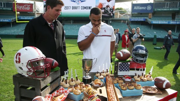 Feast of football: Three-time Super Bowl champion Ed McCaffrey (left) and Solomon Thomas look over a sample of American classics that will be available to fans in Sydney when the Stanford University take on Rice University in August.