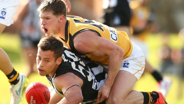 Ben Moloney of Collingwood is tackled by Matthew Arnot of Richmond during the round 19 match on Saturday.