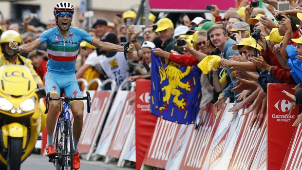 Astana rider Vincenzo Nibali of Italy celebrates as he crosses the finish line to win 19th stage in La Toussuire-Les Sybelles in the French Alps.