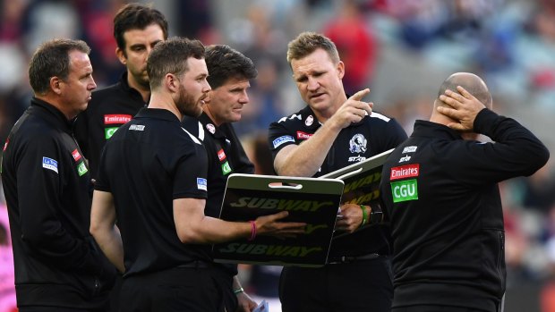 Coach talk: Nathan Buckley talks to his coaching staff during the round four match against the Demons.