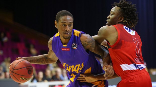 Making a splash: Kings import Greg Whittington is guarded by Perth's Jaron Johnson during the Australian Basketball Challenge match at Brisbane Convention and Exhibition Centre.