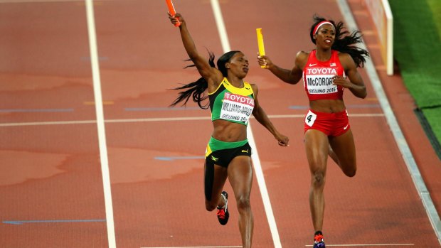 Novlene Williams-Mills of Jamaica crosses the line to win gold ahead of Francena McCorory of the United States in the women's 4x400 relay at the World Athletics Championships in Beijing on Sunday.