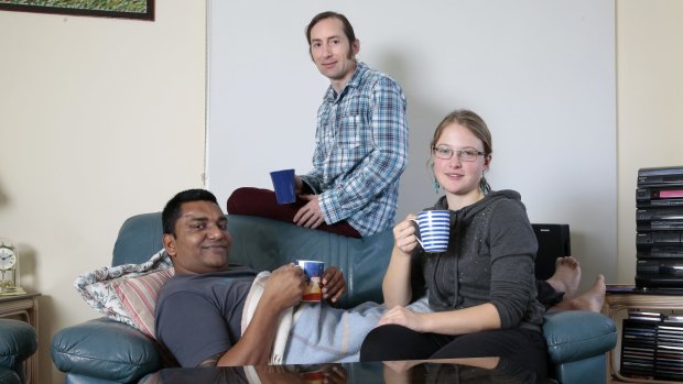 Sunday Times. Melbournians Ann Herget, left and Harsh Gupta, centre, are coach surfing guests of Noni Ivkovica, right, at his Macgregor home. 9 May 2015. Canberra Times photo by Jeffrey Chan.