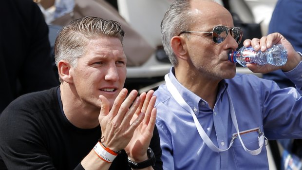 German soccer star Bastian Schweinsteiger (left) watches the match between Ivanovic and Vekic.