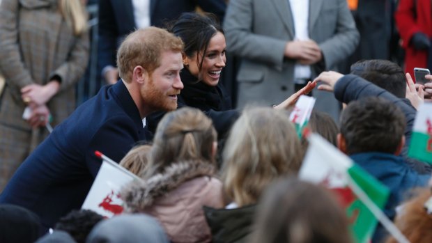 Britain's Prince Harry and his fiancee Meghan Markle meet fans as they arrive for a visit to Cardiff Castle in Cardiff, Wales, on Thursday, Jan.18, 2018.