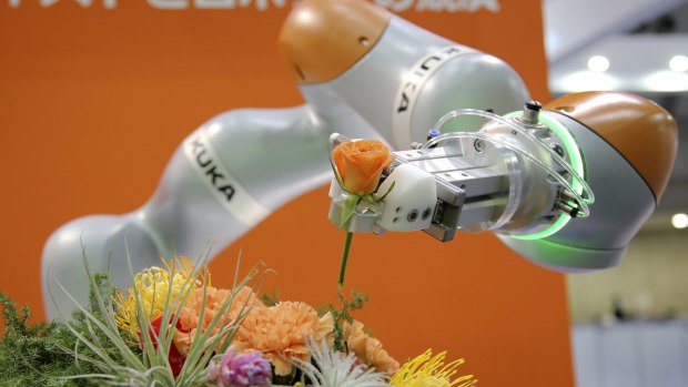 A robot arranging flowers at the International Robot exhibition in Tokyo last year. 