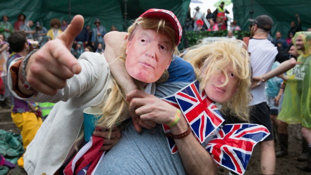 Men dressed as Boris Johnson and Donald Trump take part in a tomato fight at England's Glastonbury Festival.