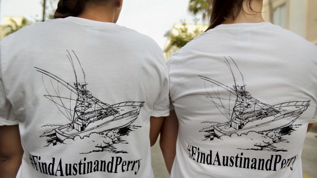 Girls wear t-shirts they bought to help fund the ongoing private search for Nick Cohen and Austin Stephanos.