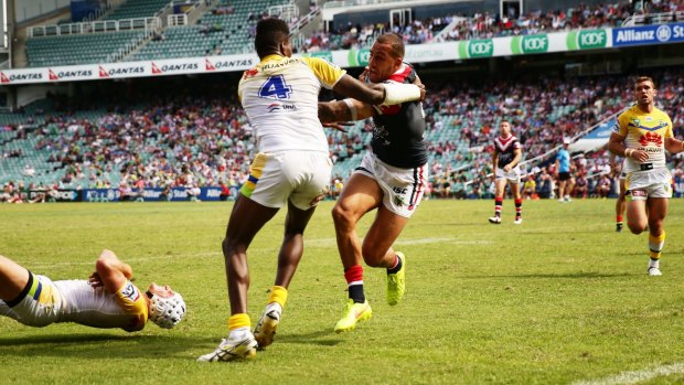 Roosters centre Blake Ferguson beats Edrick Lee to score a try during Sunday's match. 