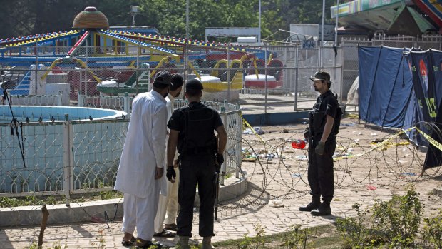 Pakistani police cordon off the area of the bombing at an amusement park in Lahore.