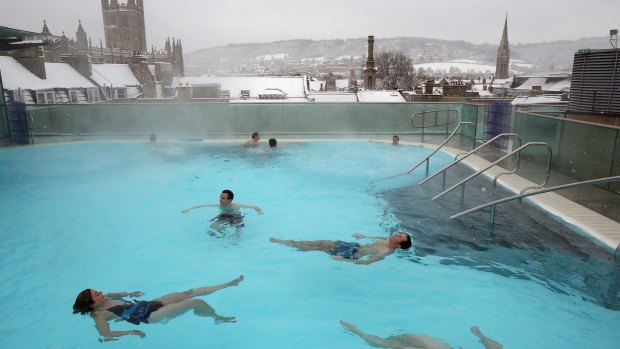Bathers enjoy the rooftop pool at the Thermae Bath Spa in the snow in Bath, England.