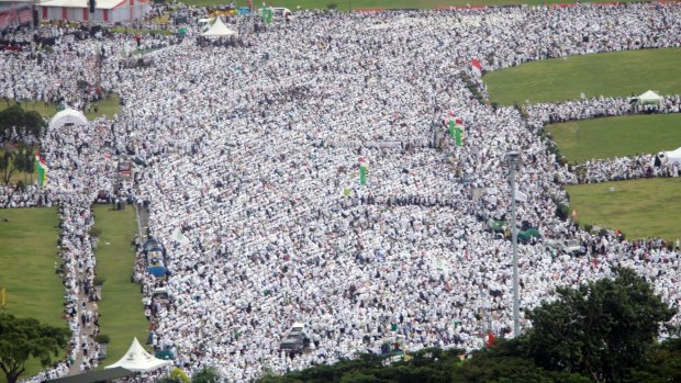 Indonesian Muslims gather at the National Monument in Jakarta during a rally against governor Basuki "Ahok" Tjahaja Purnama, who is being prosecuted for blasphemy.